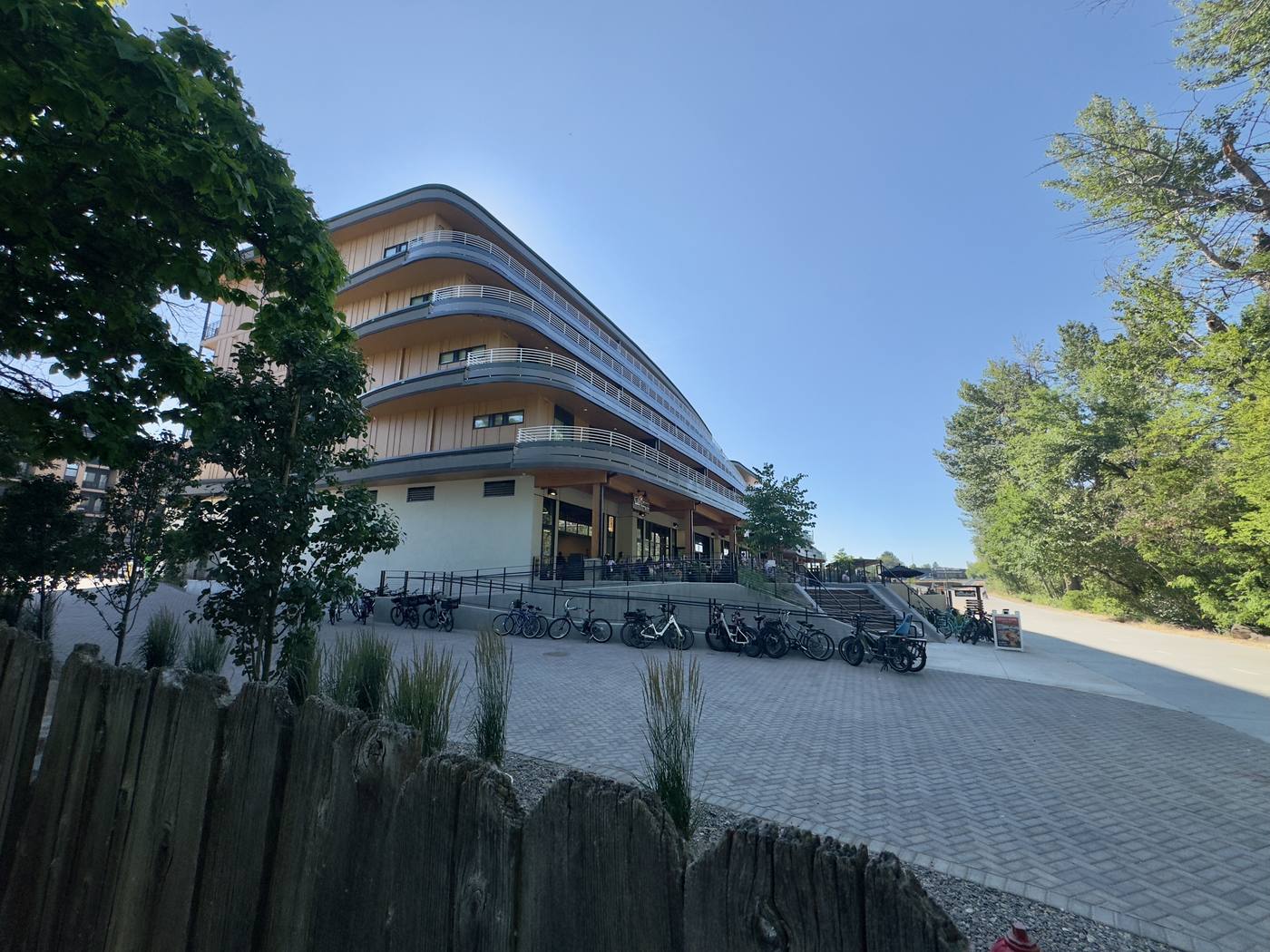 The Boardwalk seen from the Greenbelt in daylight, bikes racked along the frontage