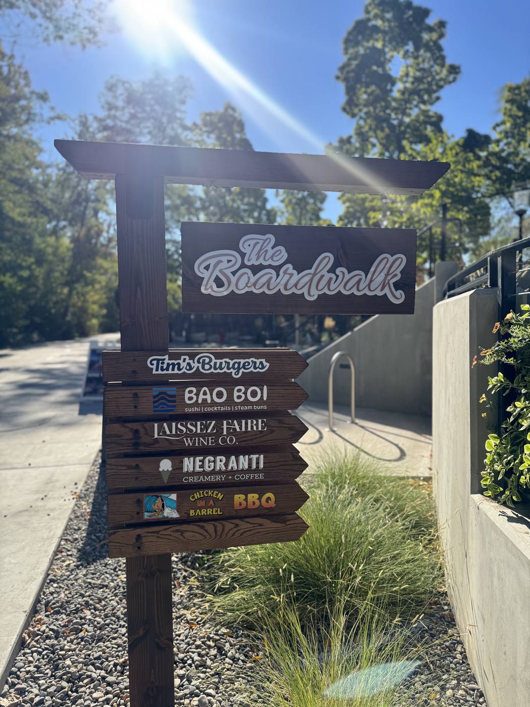 The Boardwalk sign at the entrance, listing the restaurants and shops along the river walk